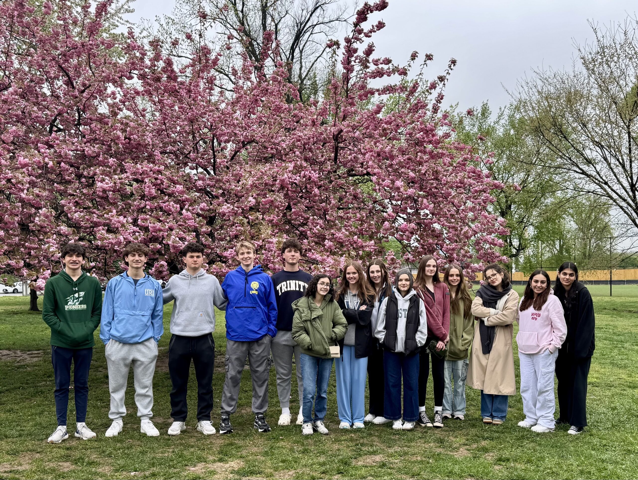 Participants from the Interfaith Teen Leaders' trip to DC stand together, enjoying the cherry blossoms.