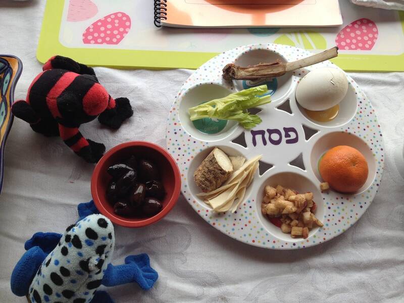A traditional Passover seder plate with symbolic foods—matzah, maror (bitter herbs), charoset, karpas (parsley), zeroa (shank bone), and beitzah (egg)—representing the Exodus story.