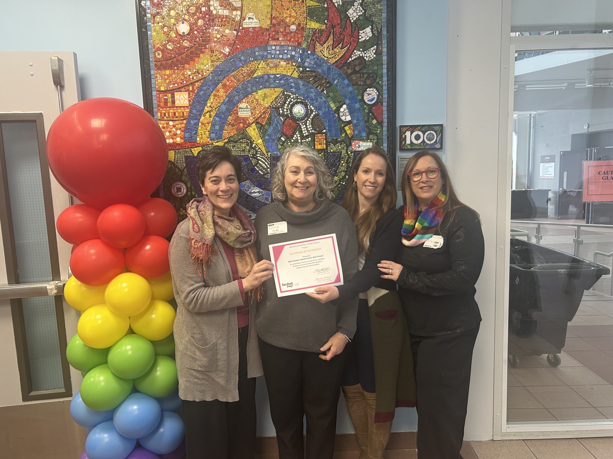 Members of the Keshet Cohort celebrate Pride with rainbow balloons