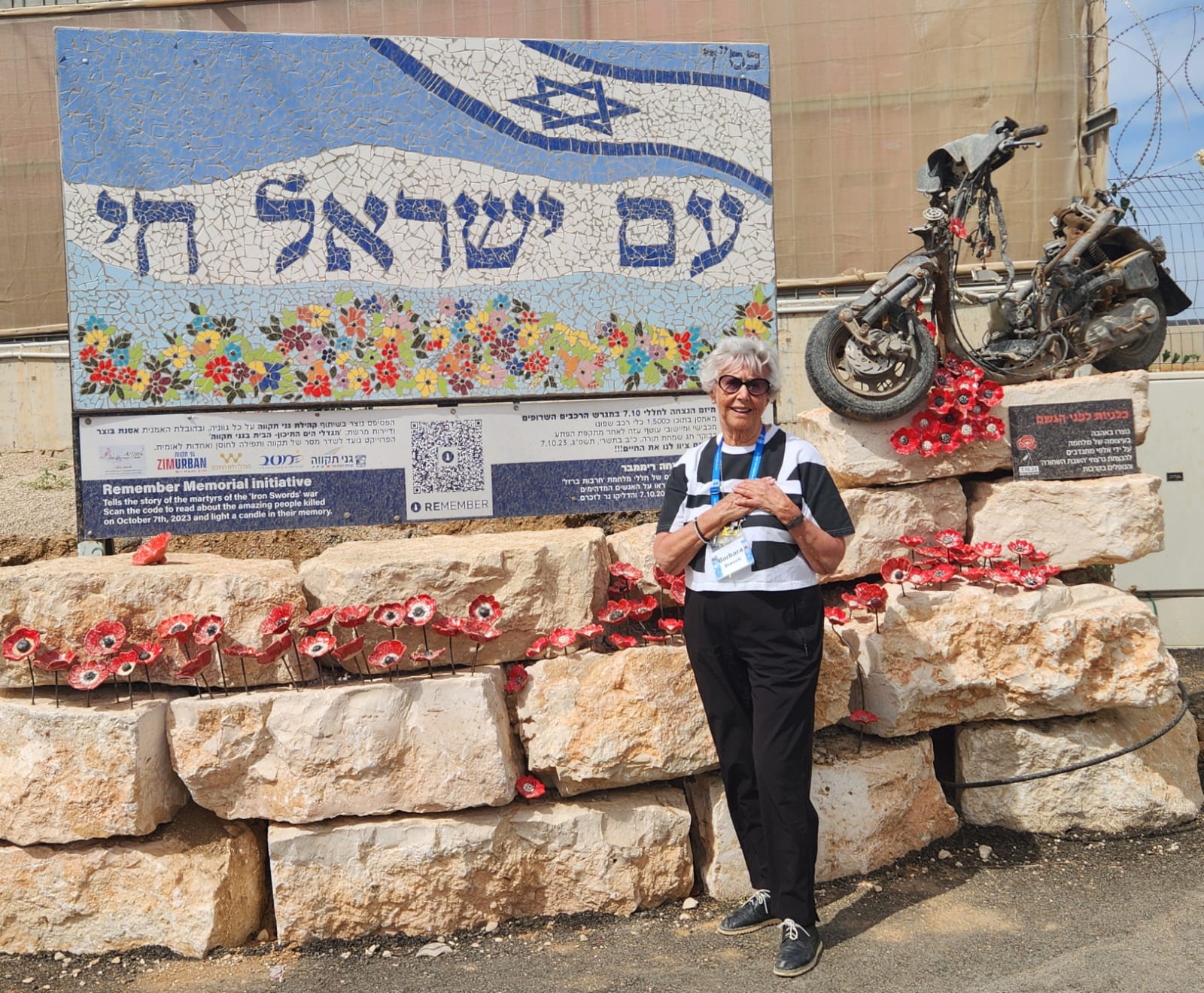 Barbara Drench stands in front of an 'Am Yisrael Chai' poster in Israel while on March of the Living.