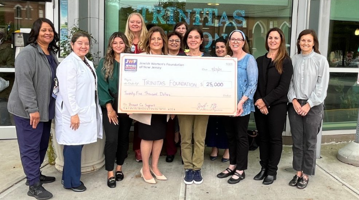 Representatives from Trinitas and JWF hold $25,000 check