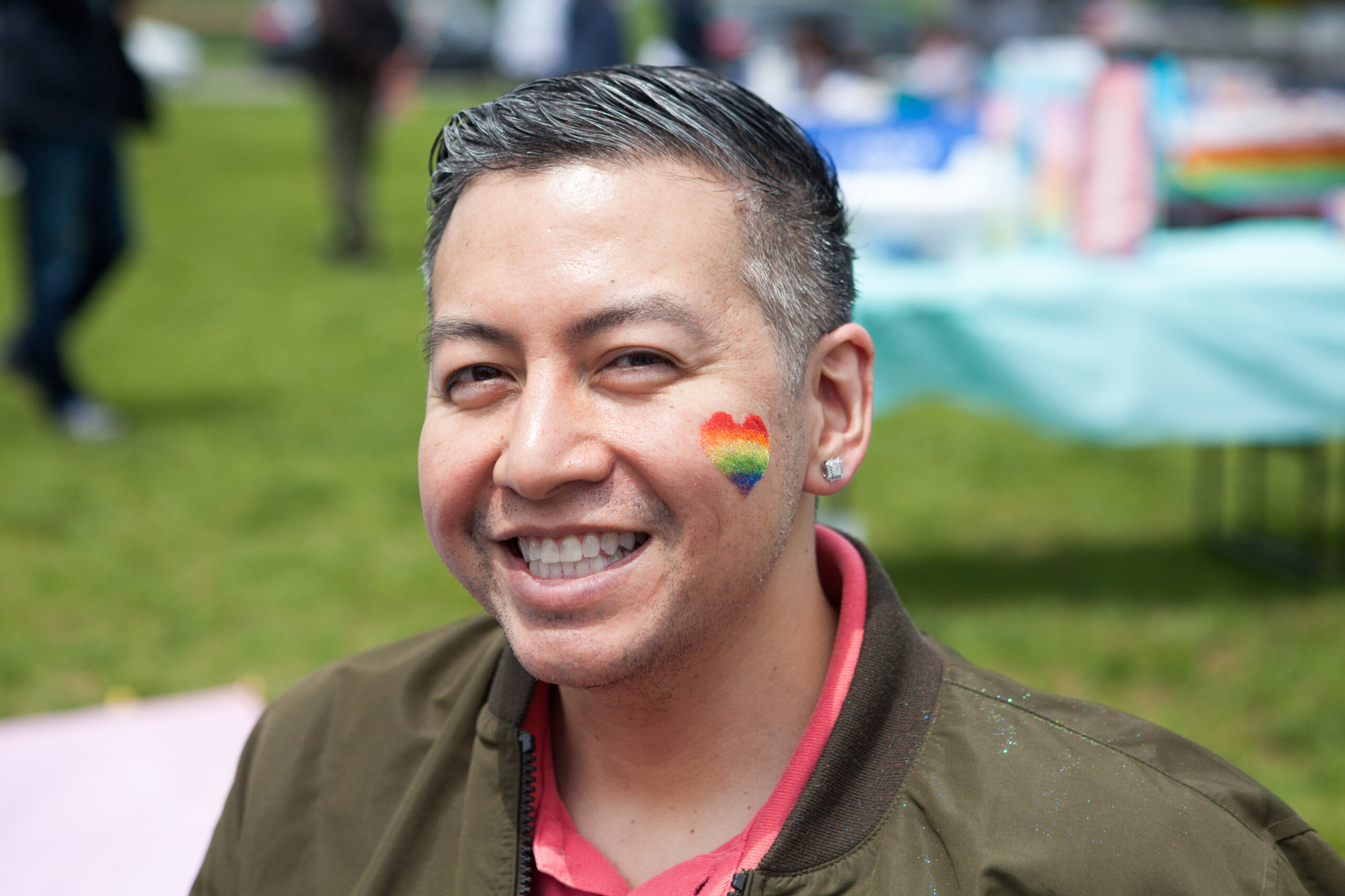 Honeymoon Israel participant at Federation's Pride Gathering with rainbow heart on his face.