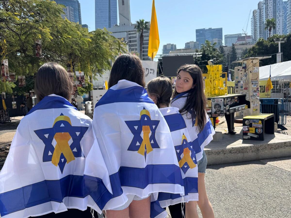 Greater MetroWest teens during an Israel experience wearing Israeli flags with yellow ribbon.