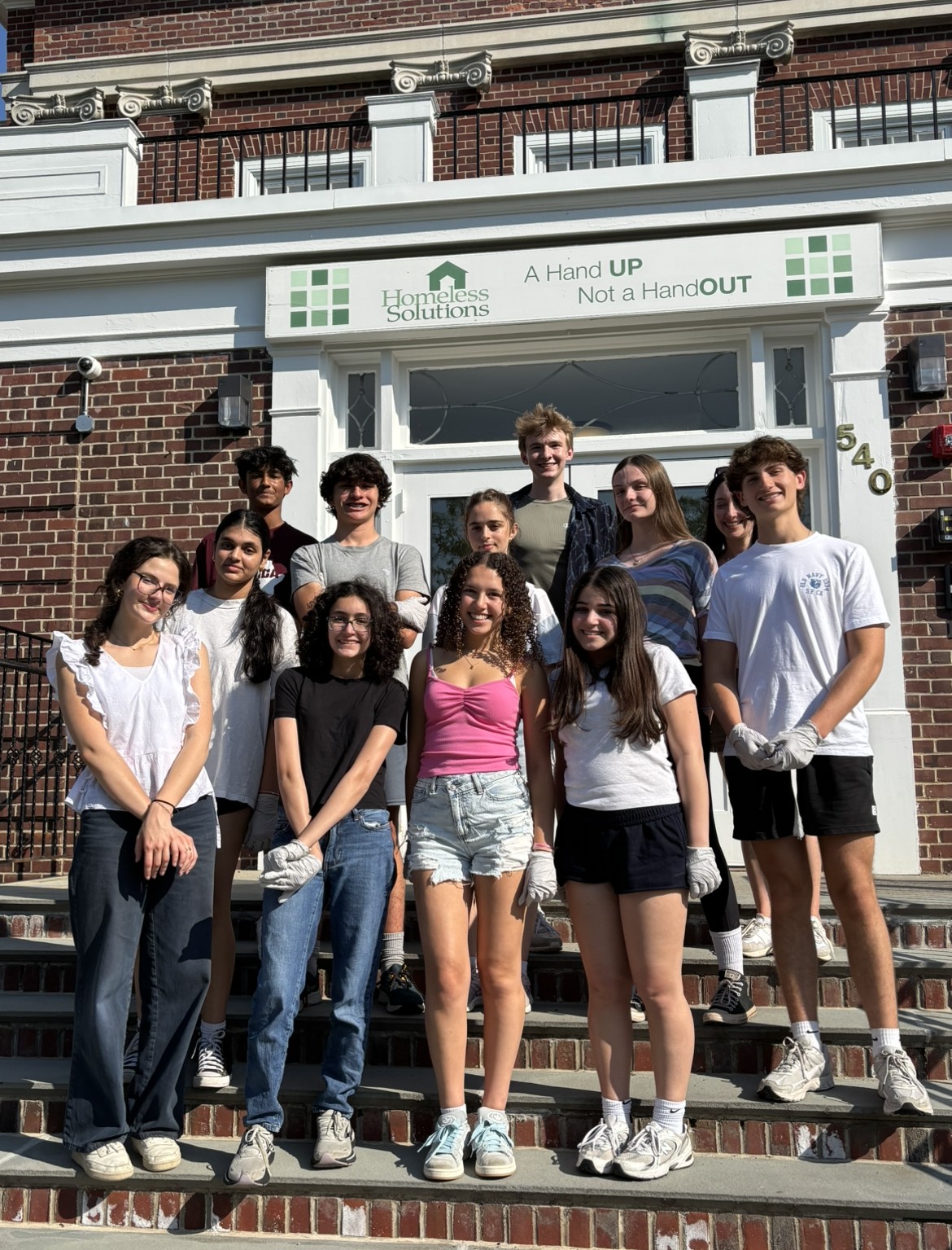Etienne with his fellow Interfaith Teen Leaders outside of Homeless Solutions building