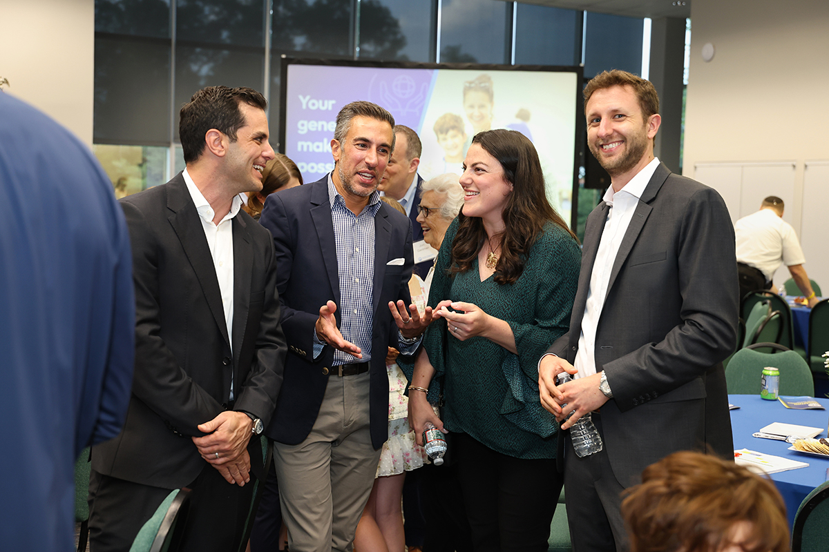 A group of four people having a conversation at a NextGen event.