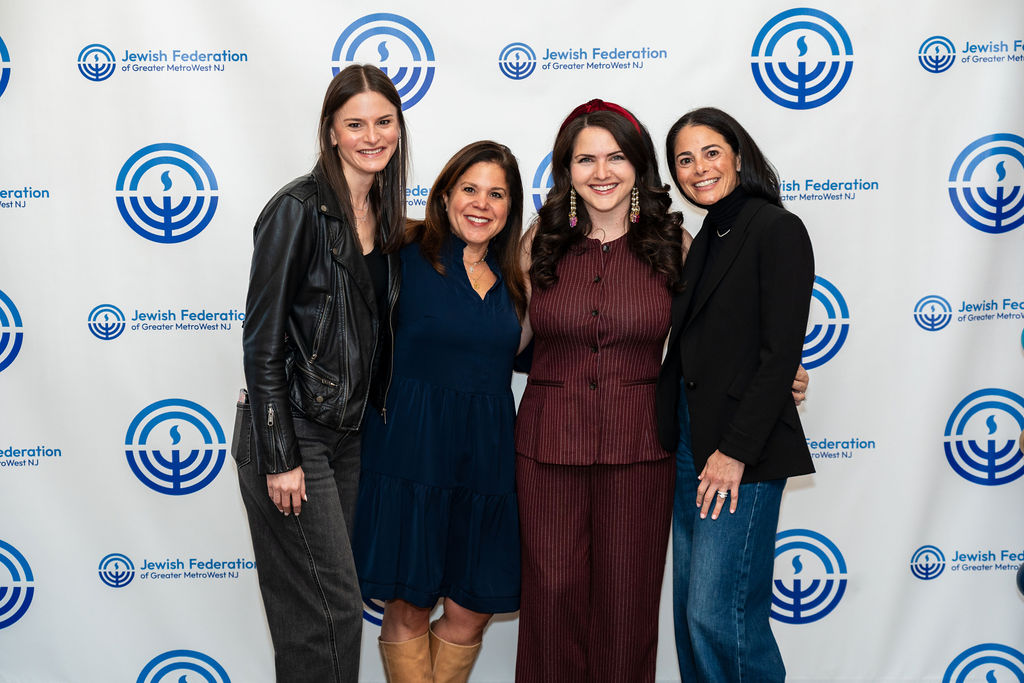 Four women standing next to each other at a NextGen event.